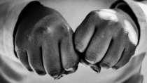 grayscale photo of persons hand with ring